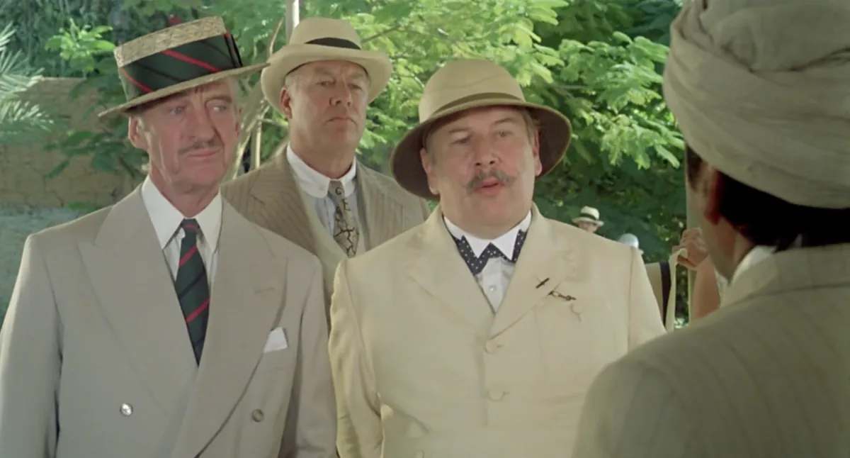 Peter Ustinov as Poirot and fellow travelers outdoors in Death on the Nile (1978).