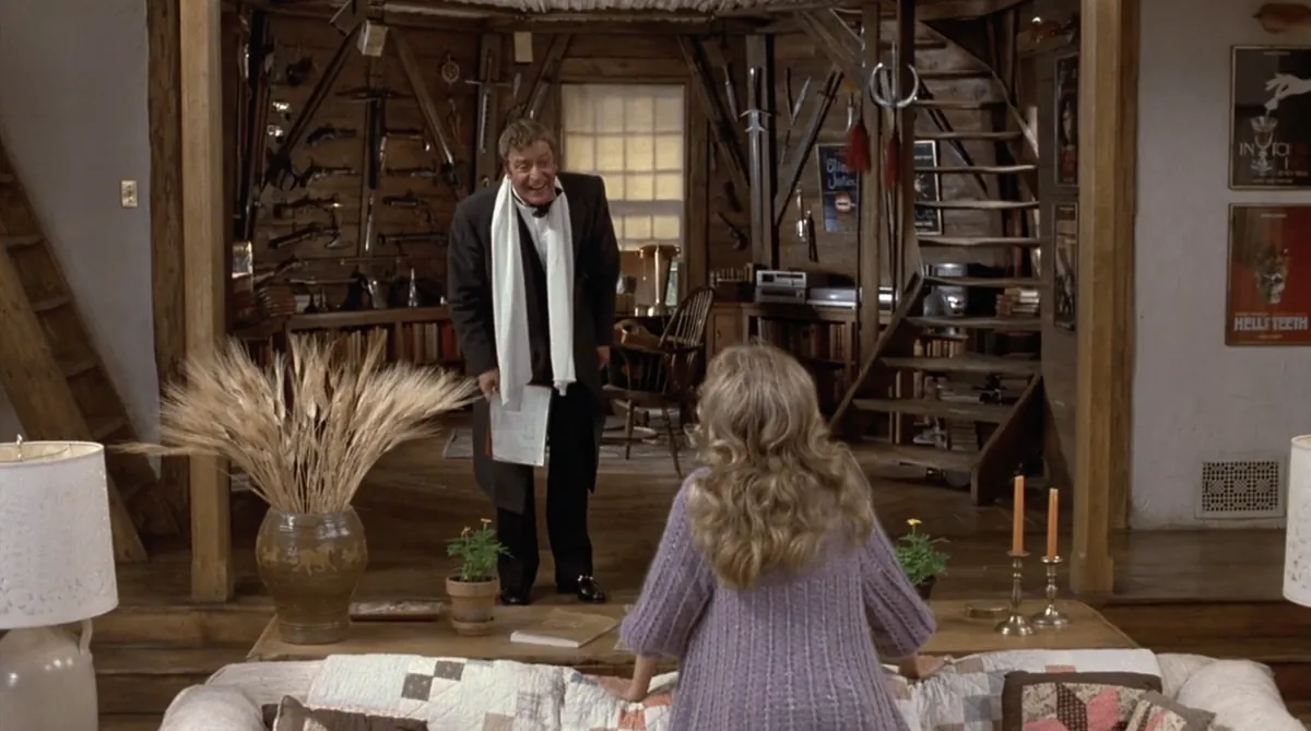 Michael Caine addresses Dyan Cannon in a room lined with weapons and theatre posters in Deathtrap (1982).